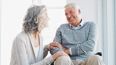 Buy stock photo Shot of a senior man in a wheelchair being cared for by his wife