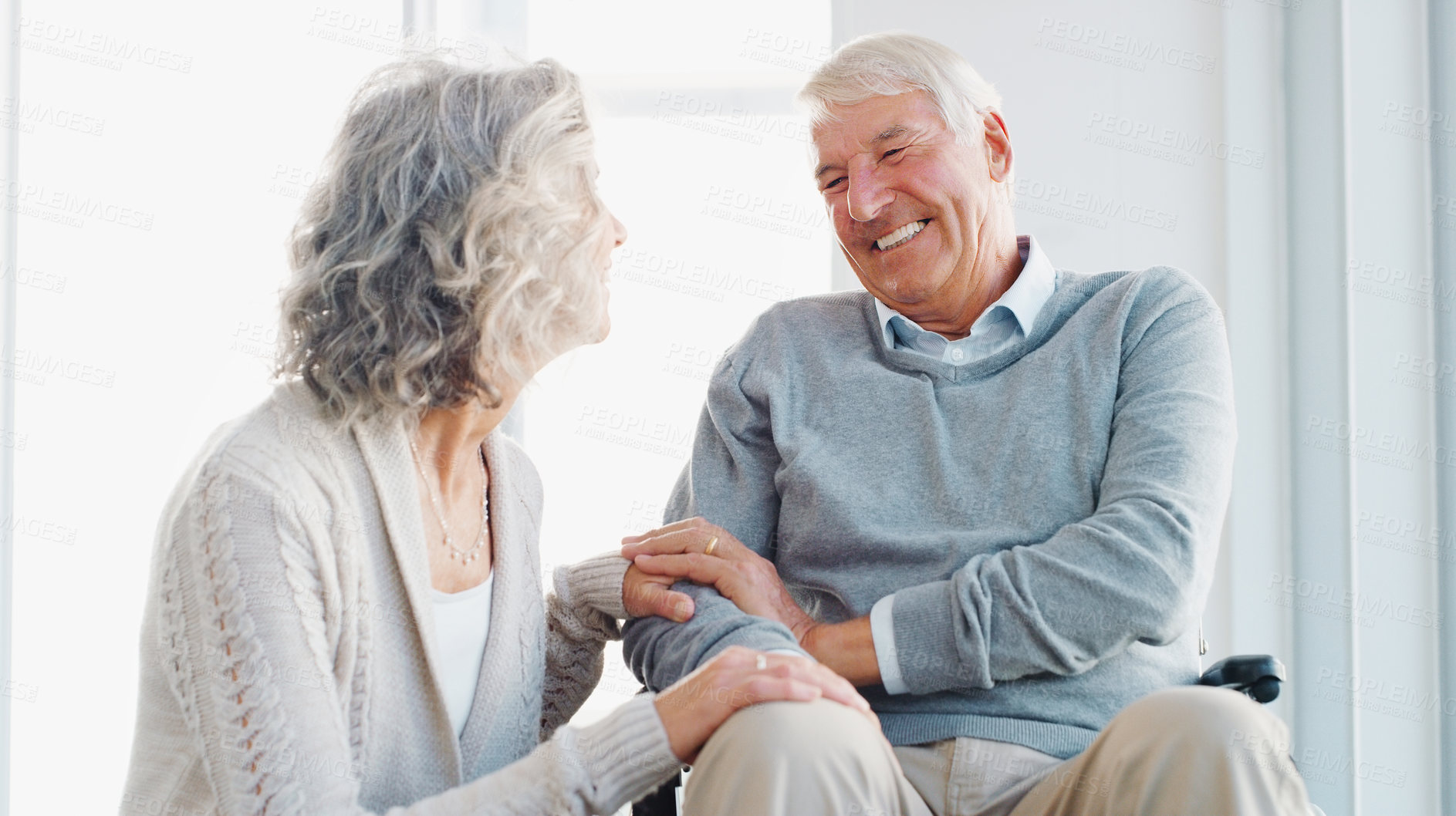 Buy stock photo Shot of a senior man in a wheelchair being cared for by his wife