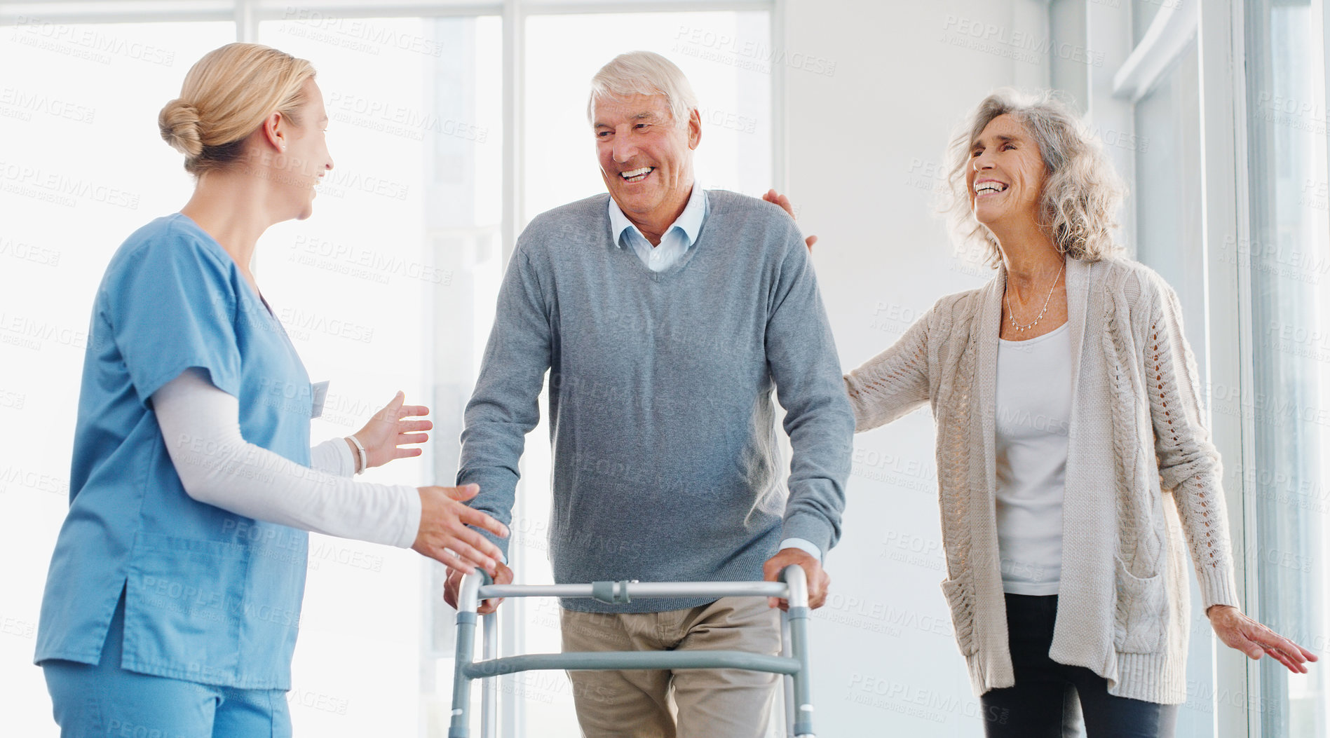 Buy stock photo Caregiver, walking and old man with walker, happy and senior couple with love and elderly patient with disability. Clinic, nurse and grandpa with wife, wellness and compassion for healthcare or smile