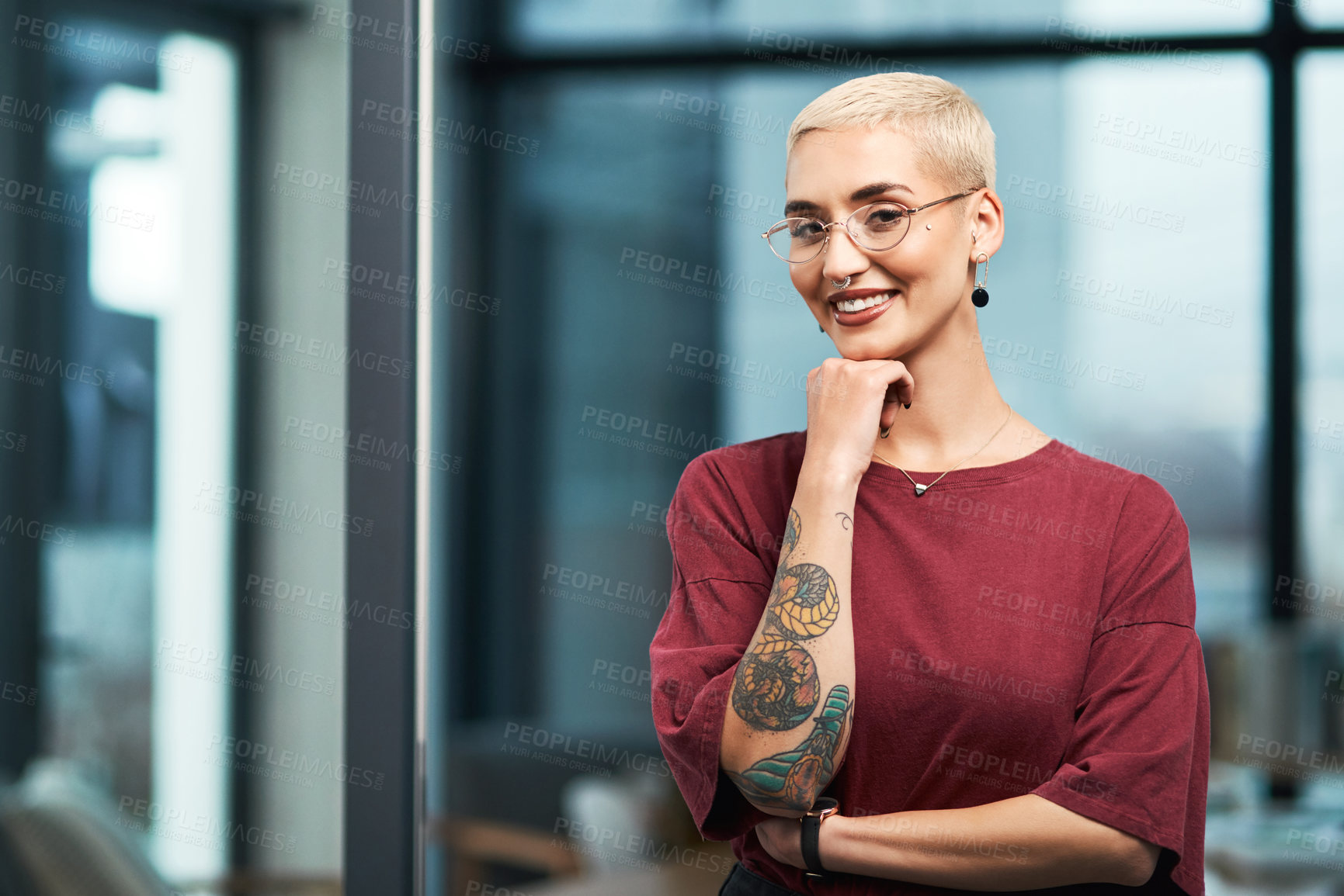 Buy stock photo Cropped portrait of an attractive young businesswoman standing alone in her office and resting her hand on her chin