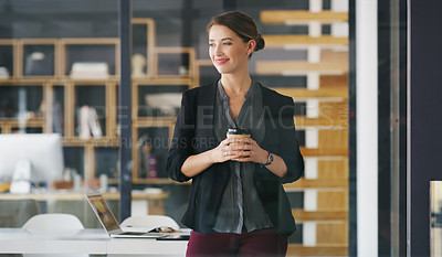 Buy stock photo Cropped shot of an attractive young businesswoman standing alone in her office and holding a cup of coffee