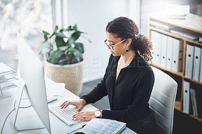 Buy stock photo Shot of a young businesswoman working on a computer in an office