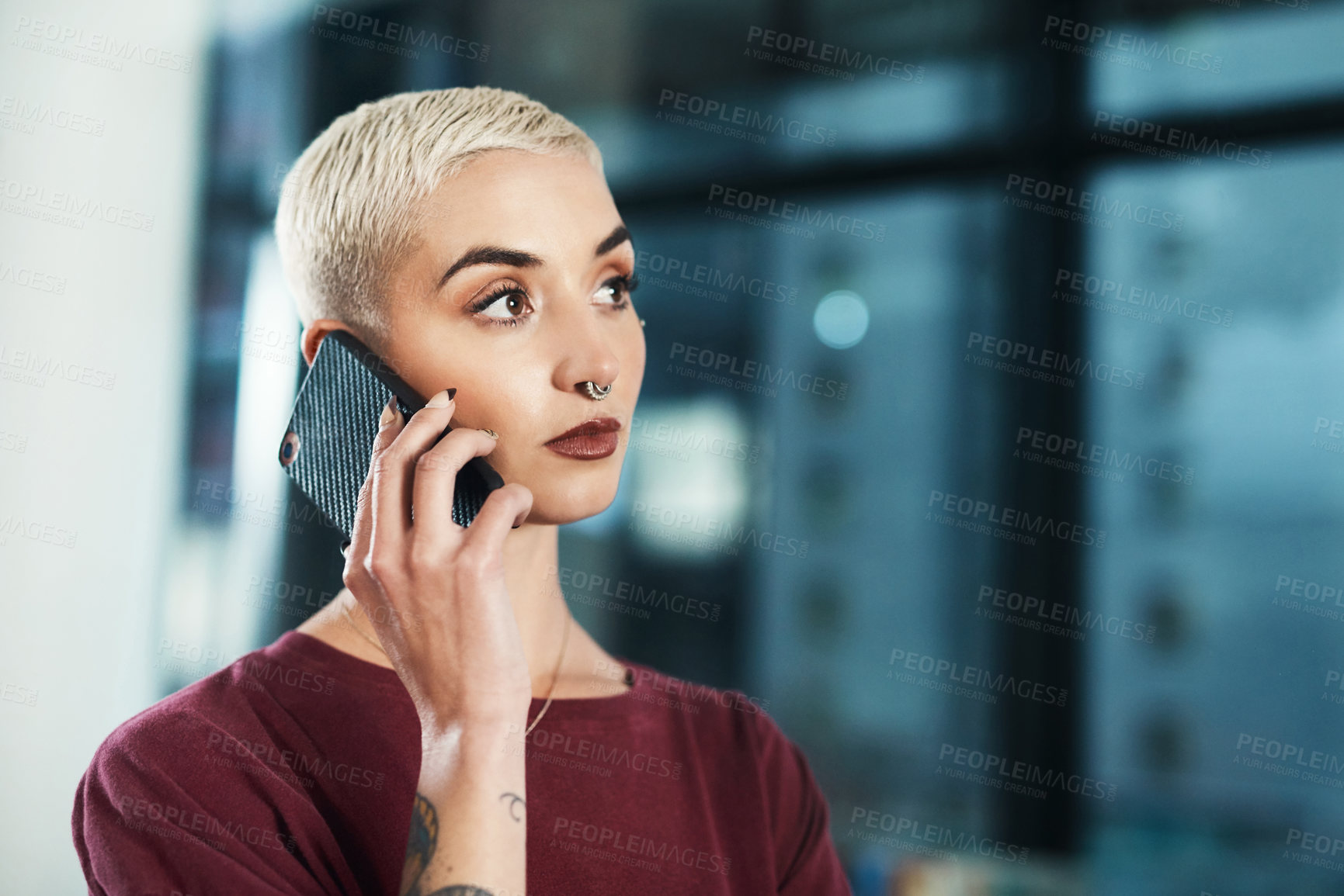 Buy stock photo Cropped shot of an attractive young businesswoman standing alone in her office and using her cellphone