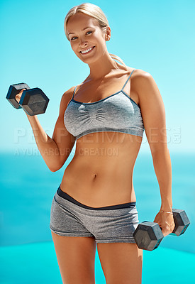 Buy stock photo Happy woman, portrait and dumbbells for weightlifting, workout or muscle training on a blue background. Young, female person or blonde with smile or weights for exercise practice or outdoor fitness