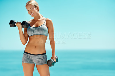 Buy stock photo Cropped portrait of a beautiful young woman working out with dumbbells outside