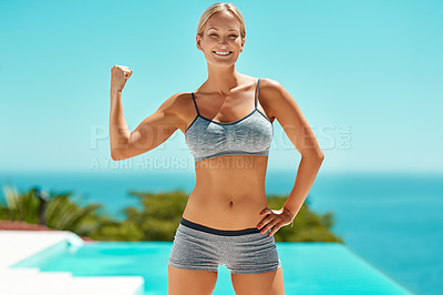 Buy stock photo Cropped portrait of an attractive young woman in exercise clothing flexing her bicep outside