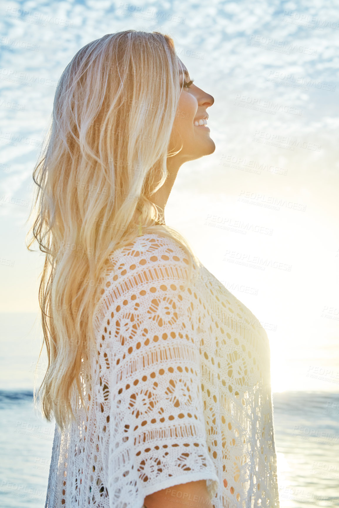 Buy stock photo Shot of a beautiful woman spending time at the beach on a sunny day