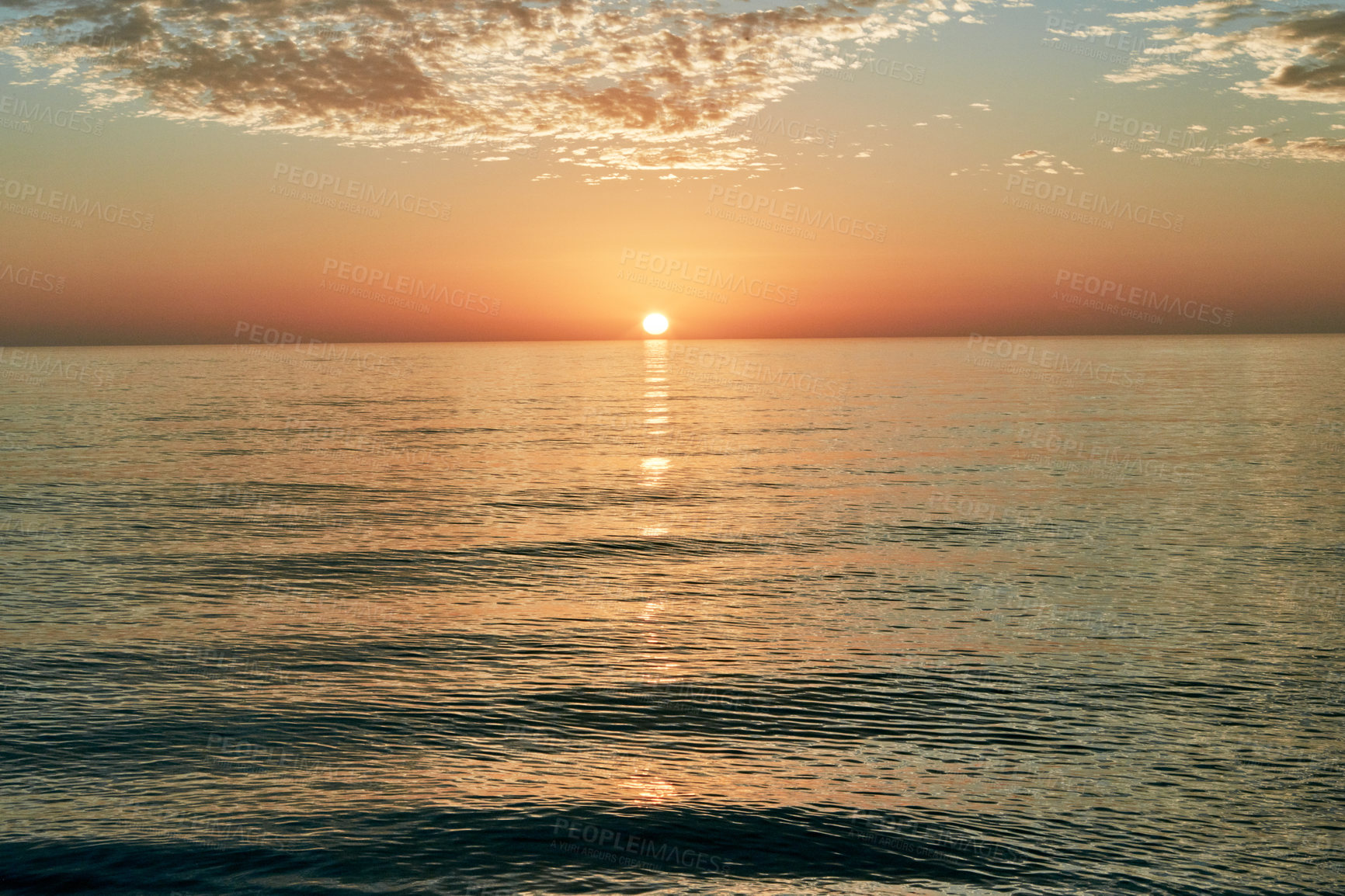 Buy stock photo Shot of the sun setting over the ocean