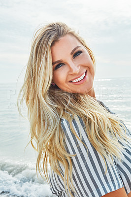 Buy stock photo Shot of a beautiful woman spending time at the beach on a sunny day