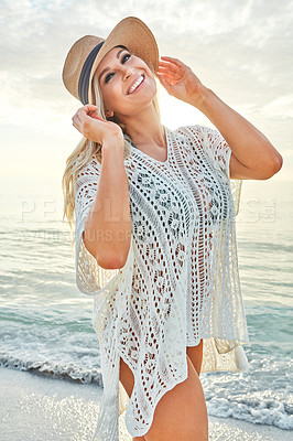 Buy stock photo Shot of a beautiful woman spending time at the beach on a sunny day