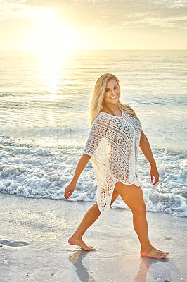 Buy stock photo Shot of a beautiful woman spending time at the beach on a sunny day