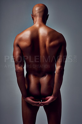 Buy stock photo Rearview studio shot of an unrecognizable young man posing nude against a grey background
