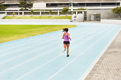 Buy stock photo Back, woman and running on race track for athletics, fitness or competition training in stadium. Runner, exercise and female person for sports performance, endurance challenge or cardio workout