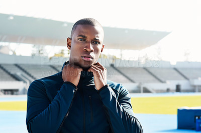 Buy stock photo Cropped portrait of a handsome young male athlete standing outside at the track