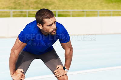 Buy stock photo Fatigue, fitness and running with sports man in stadium venue for competition or performance. Exercise, tired and training with athlete or runner in recovery from track and field marathon or race