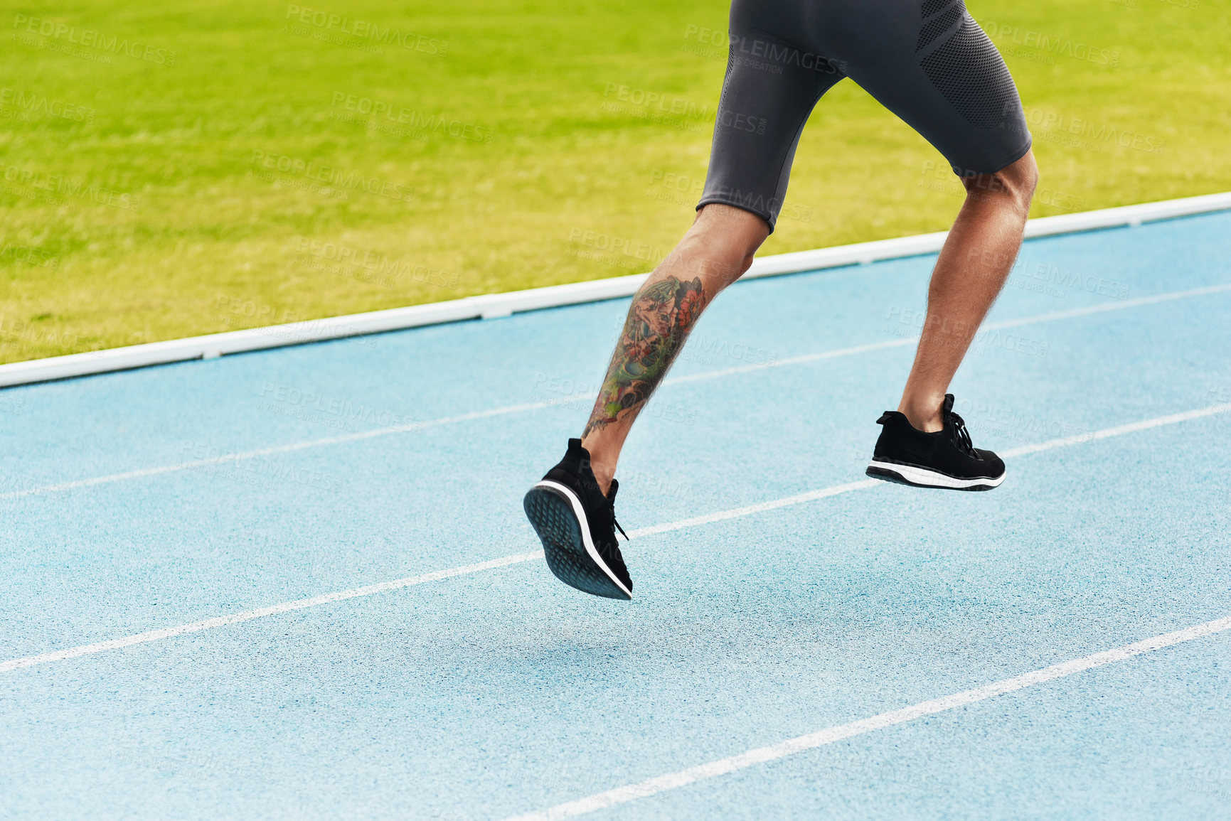 Buy stock photo Man, legs and running on track for athletics, fitness or exercise of athlete training at the stadium. Leg of male person or runner exercising in run, workout or sports competition for healthy cardio