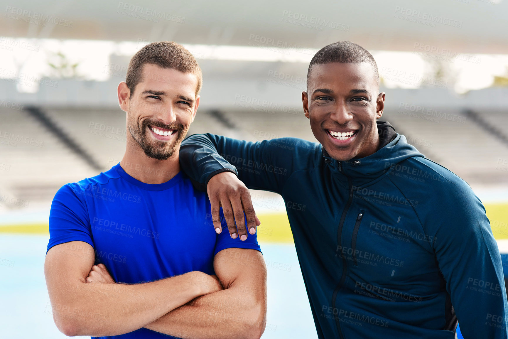 Buy stock photo Cropped portrait of two handsome young male athletes standing outside at the track
