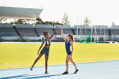 Buy stock photo Woman, team and high five on stadium track for running, exercise or training together in athletics outdoors. Women touching hands in celebration for exercising, run or winning in teamwork and fitness