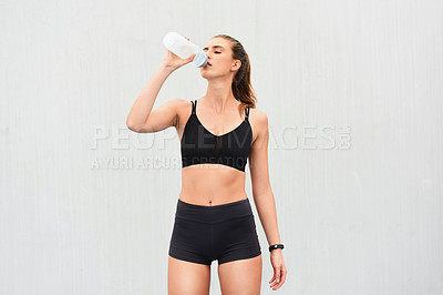 Buy stock photo Woman, athlete and drinking water in studio, thirsty and hydrate after workout on white background. Female person, detox and mineral liquid for recovery after exercise, fitness and mockup space
