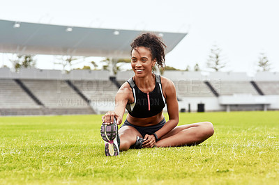 Buy stock photo Happy woman, athlete and stretching legs on grass at stadium getting ready for running, workout or exercise. Active female person or runner in warm up leg stretch, athletic fitness or sports on field