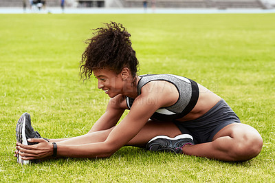 Buy stock photo Happy woman, athlete and stretching body on grass for running, exercise or workout at the stadium. Active female person in warm up leg stretch for fitness, sports training or cardio run on the field