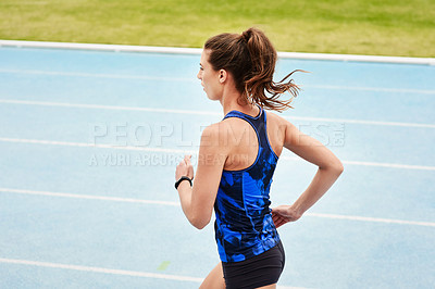 Buy stock photo Running, race track and woman for fitness, exercise and workout for sport outdoor by grass or field. Stadium, runner and athlete for wellness and gym for cardio, training and health in back view