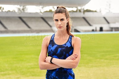 Buy stock photo Cropped portrait of an attractive young female athlete standing with her arms folded on the track