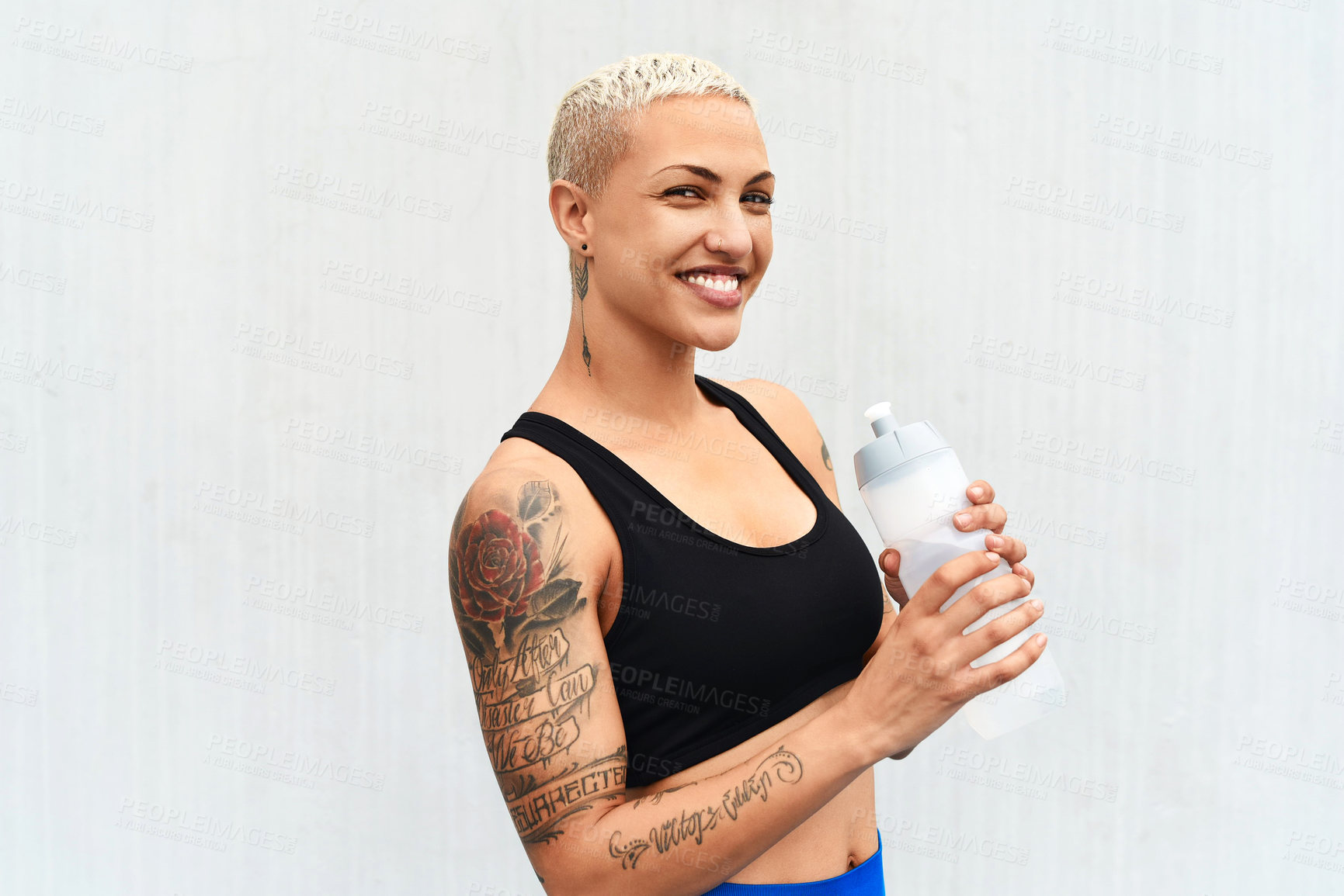 Buy stock photo Woman, athlete and drinking water in studio, portrait and hydrate after workout on white background. Female person, nutrition and mineral liquid for recovery after exercise, fitness and mockup space