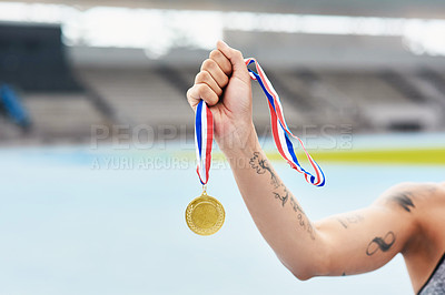 Buy stock photo Person, medal and winning hand at outdoor stadium for competition success, achievement or performance. Champion, gold award and celebration of running contest for fitness, health and wellness