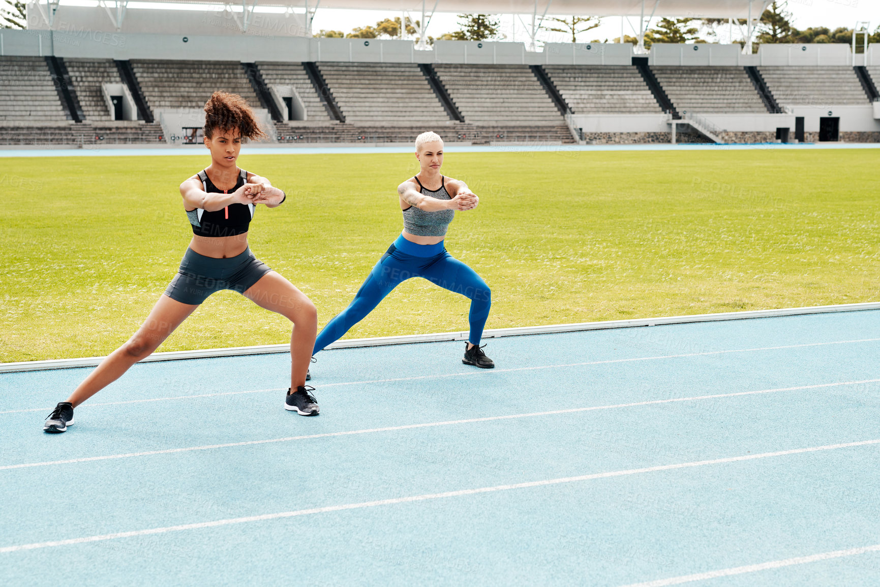 Buy stock photo Fitness, running and stadium with friends stretching on track at venue in preparation of competition or race. Exercise, training and warm up with athlete or runner people getting ready for event