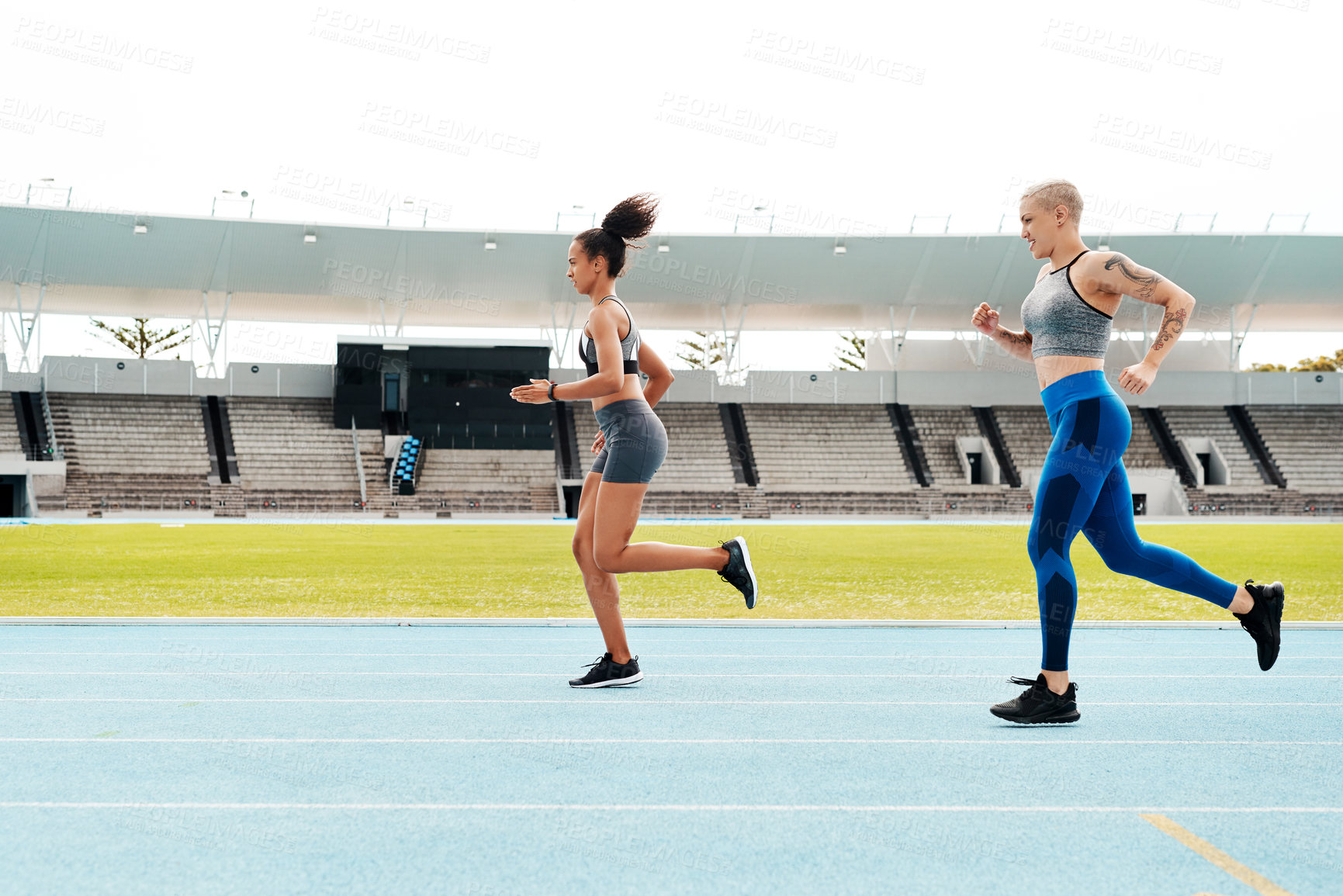 Buy stock photo Track field, fitness and women running at stadium with energy, speed and resilience training, Arena, race or marathon competition with competitive athlete runner outdoor with power, freedom or sprint