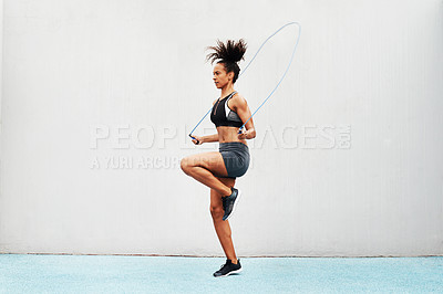 Buy stock photo Jump, skipping rope and training with woman in stadium for sports, workout practice and cardio. Performance, health and body with female athlete jumping on track for strong, mockup space and exercise