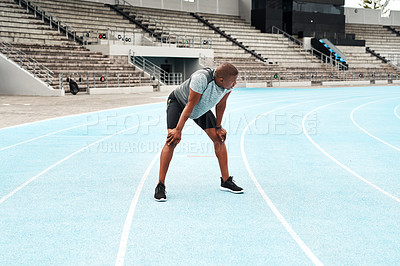 Buy stock photo Black man, athlete and breathing after running on track for exercise, fitness and cardio in stadium. African male person, workout and runner on outdoor field for sports, health and wellness 