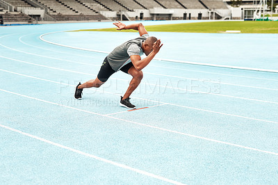Buy stock photo Black man, athlete and start position for running, cardio and fitness on outdoor track field. Male person, health and wellness outside in summer for exercise, training and workout at stadium 