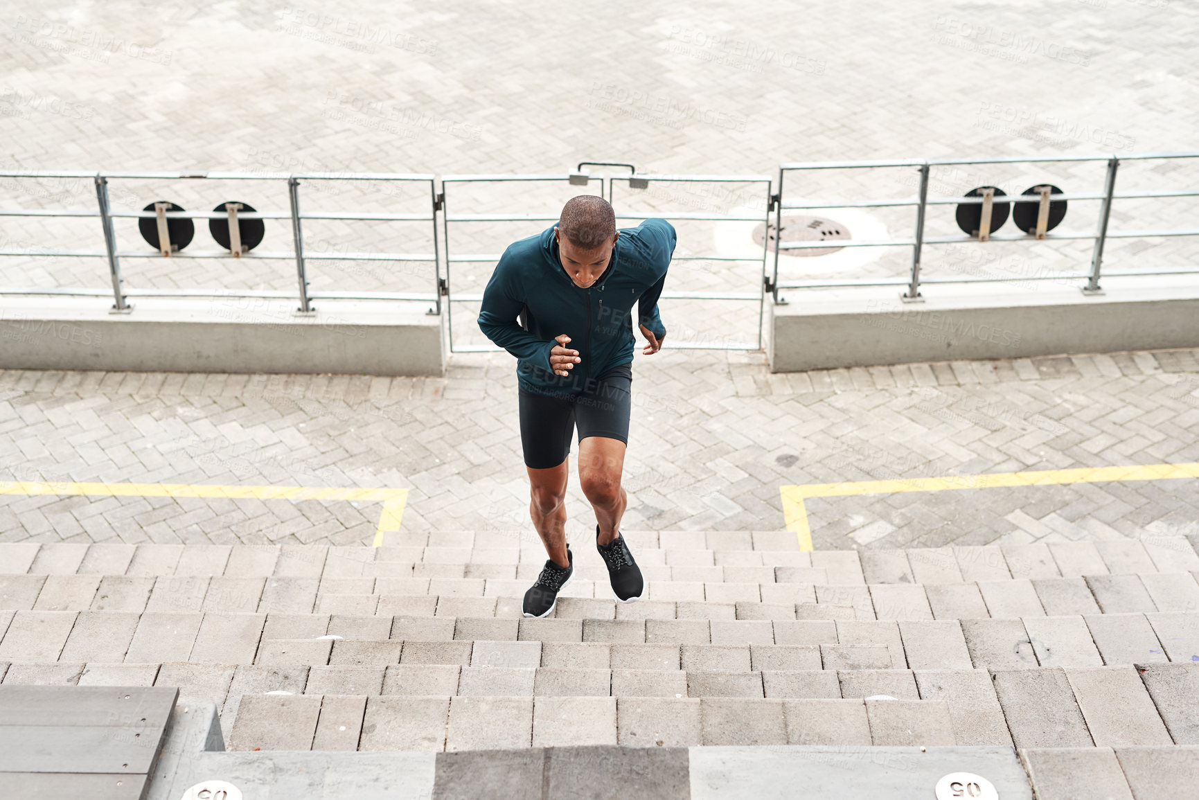 Buy stock photo Running, energy and fitness man at stadium steps for workout, resilience or training challenge. Arena, stairs and top view of runner with sports, performance or cardio exercise for marathon practice