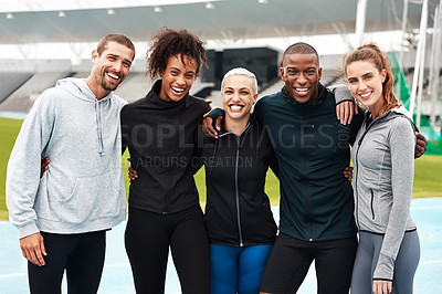 Buy stock photo Cropped portrait of a diverse group of athletes standing together and smiling after an outdoor team training session