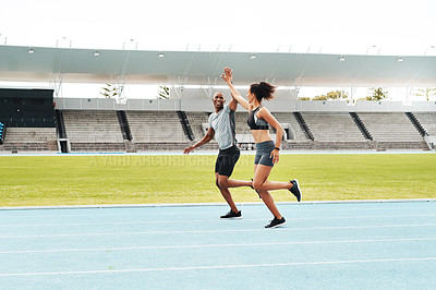 Buy stock photo Man, woman and high five for running on track for exercise, fitness and race in stadium. Male athlete, female personal trainer and success in arena for contest, competition and achievement or victory