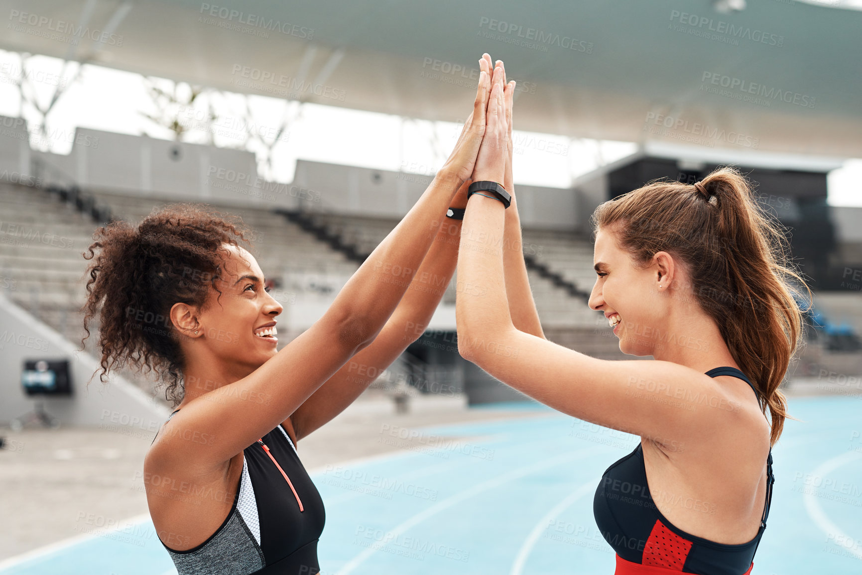 Buy stock photo Woman, teamwork and high five on stadium track for running, workout or exercise together in goal. Sports women touching hands in support, fitness or friends for motivation, unity or sport training