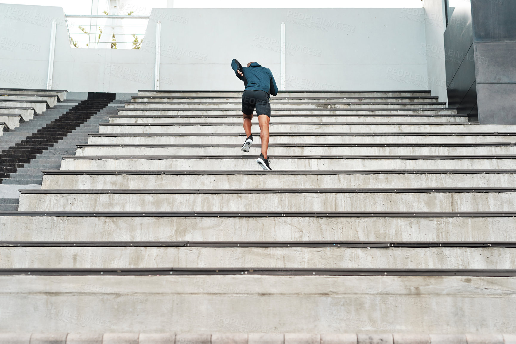 Buy stock photo Running, steps and fitness man at stadium for energy, workout or resilience, training and challenge. Arena, stairs and back of runner with sports, performance or cardio exercise for marathon practice