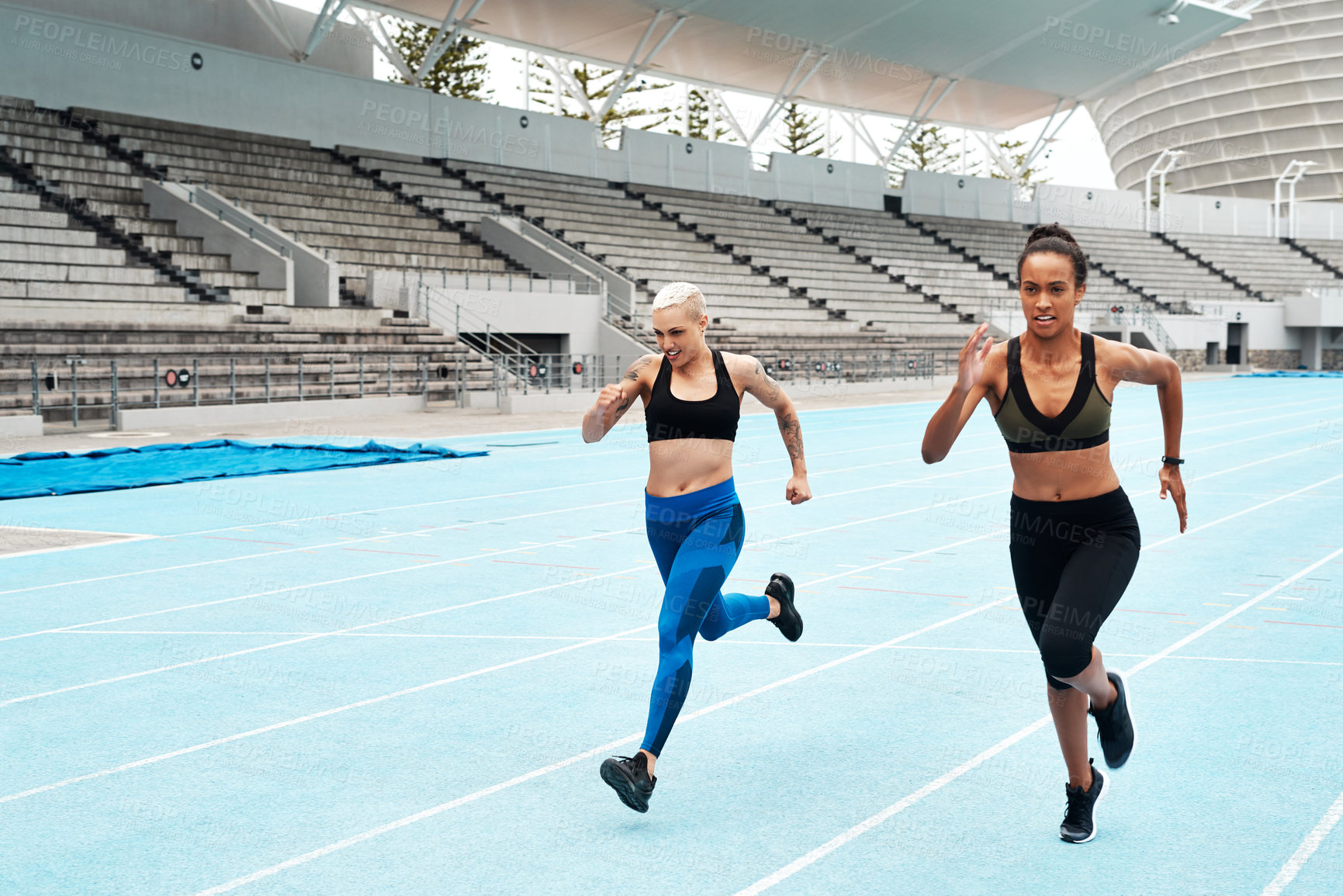Buy stock photo Race track, power and women running at stadium with energy, speed and resilience training, Arena, race or marathon competition with competitive athlete runner outdoor for fitness, freedom or sprint