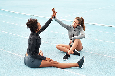 Buy stock photo Happy woman, high five and partnership on stadium track for running, workout or exercise together in teamwork. Sports women touching hands in support, fitness or friends for training motivation