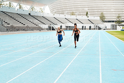 Buy stock photo Woman, athletes and running at stadium for fitness, exercise and training, speed and endurance for marathon race. People, active and field for sport with energy, power and activity for competition 
