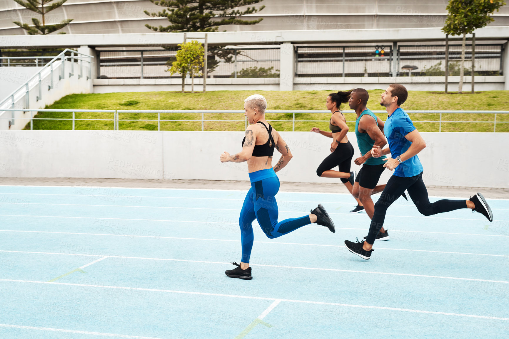 Buy stock photo Group, people and running in stadium for workout or sport on track, training or exercise for wellness. Team, athlete and arena with runner for freedom or health, commitment and strong with cardio