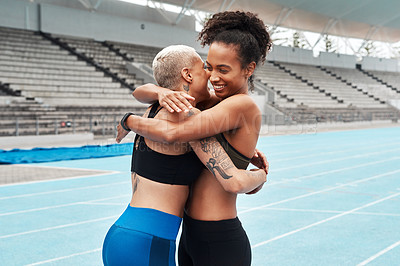 Buy stock photo Cropped shot of a two attractive young athletes hugging each other after a successful training session
