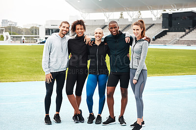 Buy stock photo Full length portrait of a diverse group of athletes standing together and smiling after an outdoor team training session