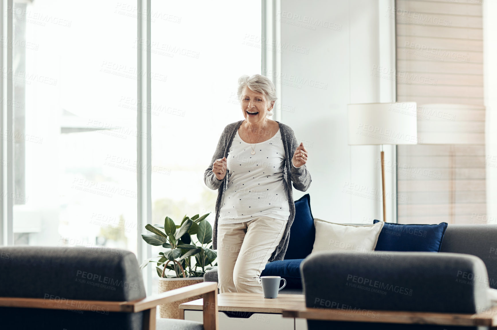 Buy stock photo Shot of a senior woman dancing at home