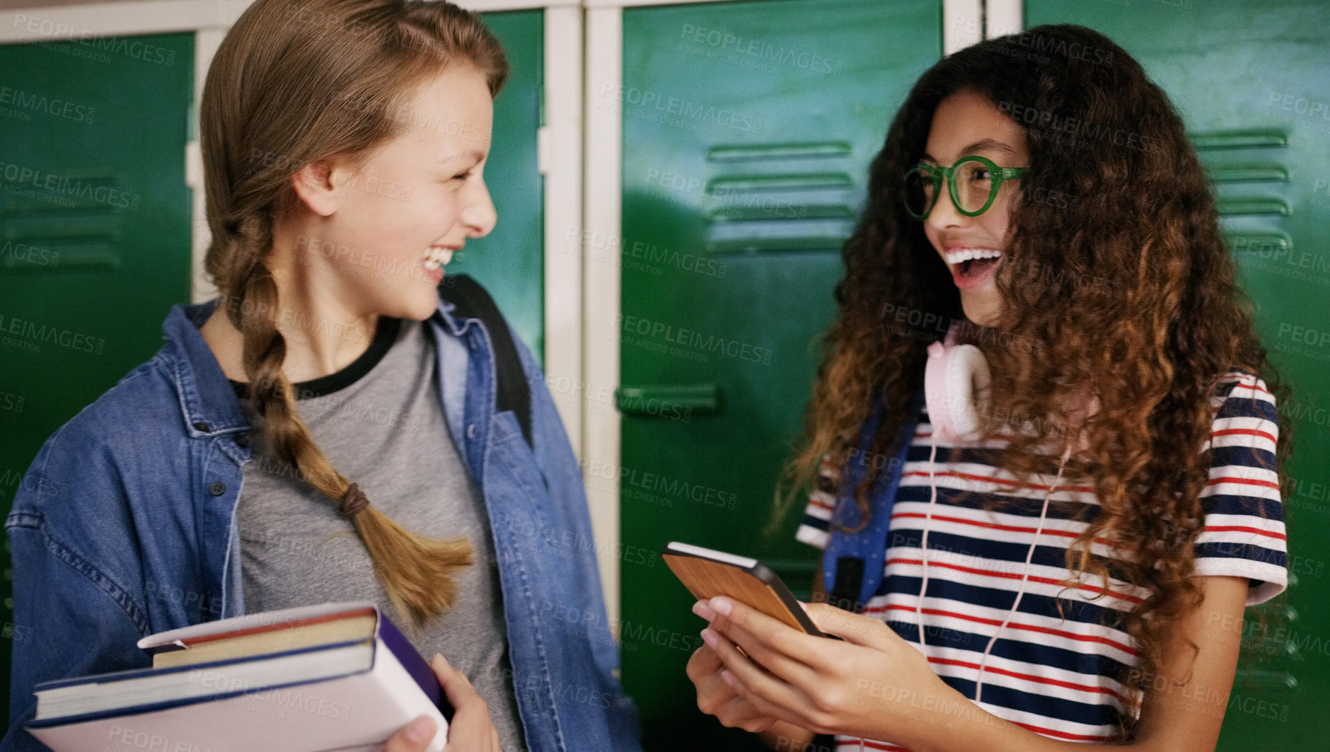 Buy stock photo Cropped shot of two young school kids having a chat before going to class inside of a school during the day