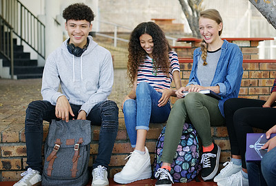 Buy stock photo Portrait of a group of cheerful young school kids hanging out together while waiting to go to class outside at a school during the day