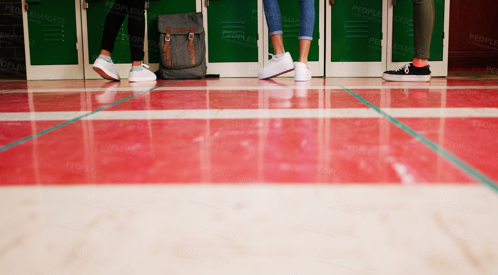 Buy stock photo Low angle shot of a group of unrecognizable student's shoes with them standing and waiting to go to class