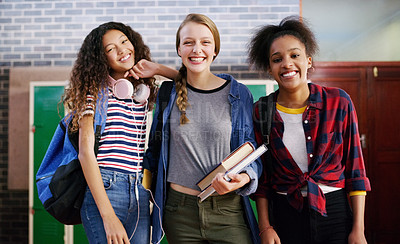 Buy stock photo Portrait of a group of young school kids standing together smiling brightly while waiting to go to class inside of a school during the day